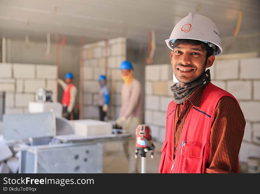 Man Wearing Red Zip-up Vest and White Helmet Smiling