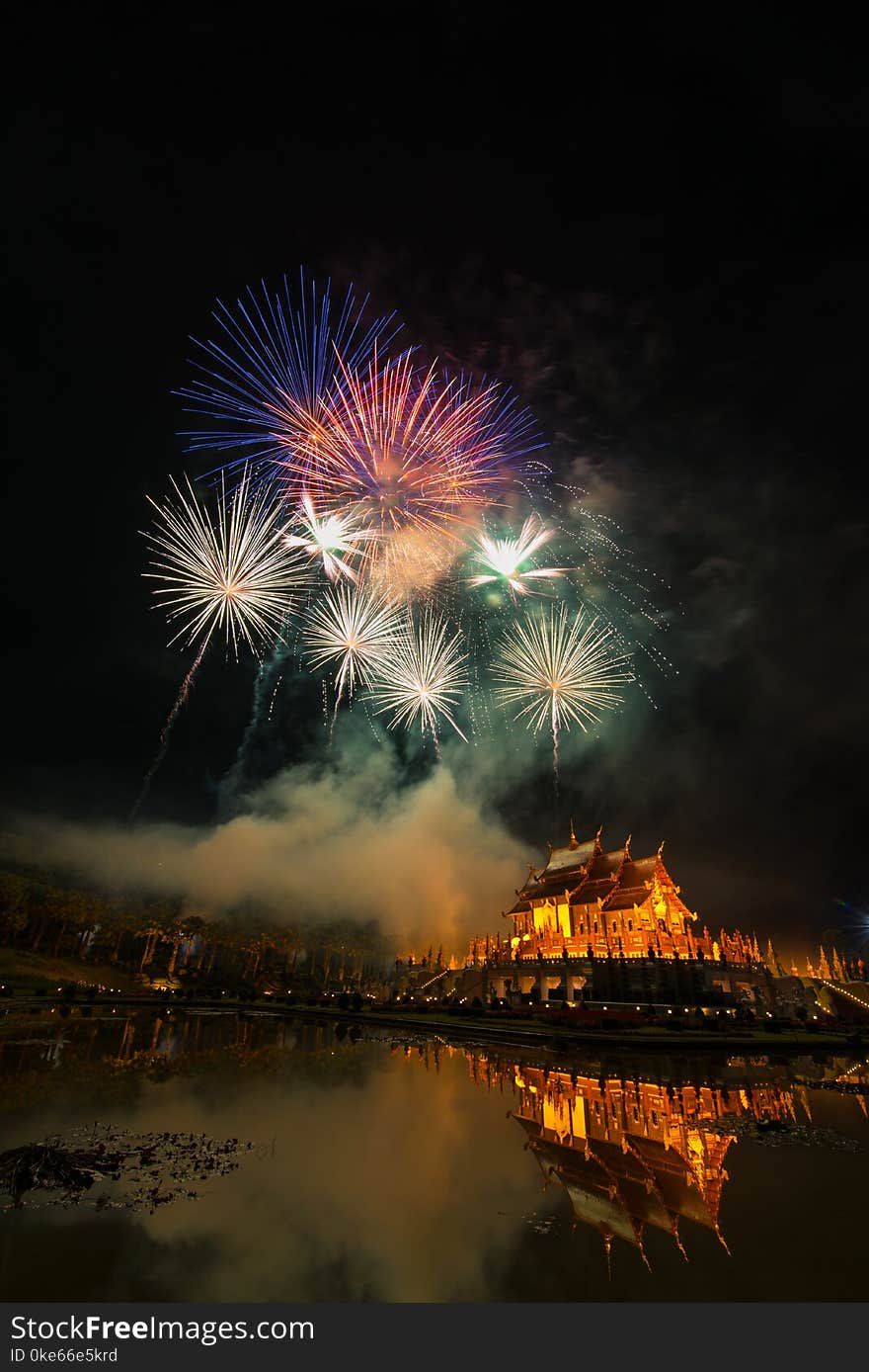 Fireworks celebrate the New Year 2018 at Rajapruek Royal Park, Chiang Mai with beutiful light of Hor Khum Luang temple,Thai Tradition Building.