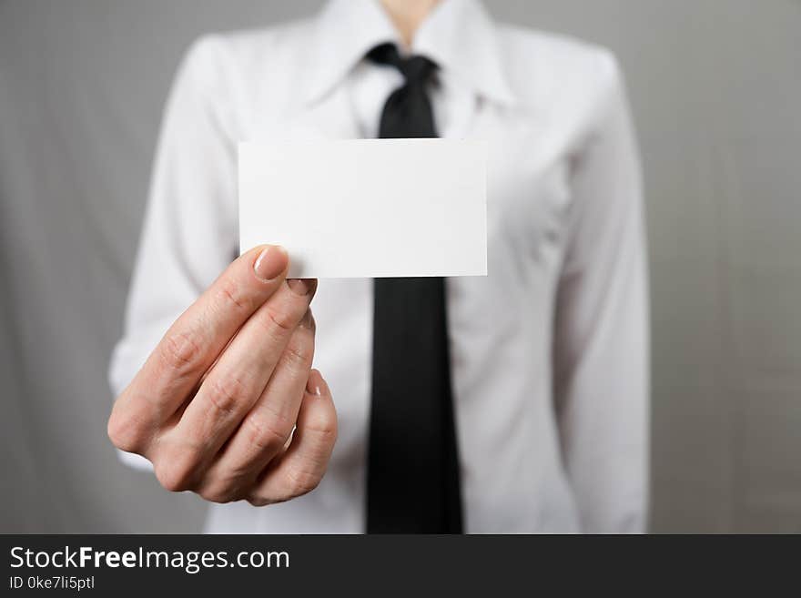 Businesswoman holding a business card. Mock up. Copy space.