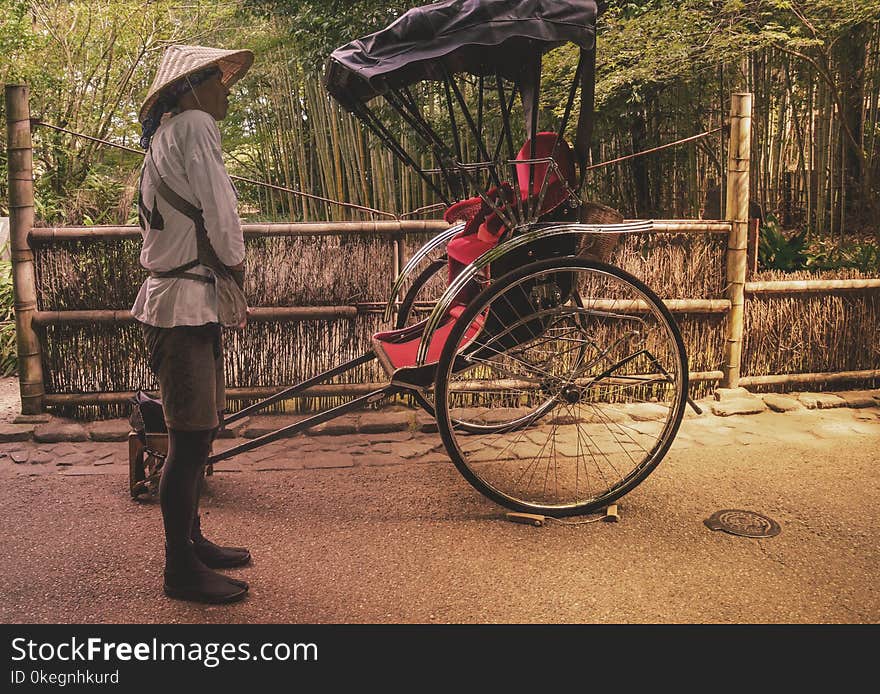 Man in Front of Black and Red Carriage