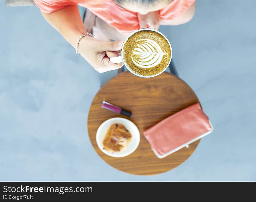 Top View Photography of a Woman Holding Coffee Cup