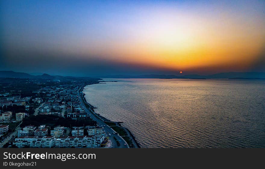 Bird&#x27;s Eye View of City Near Ocean During Dawn