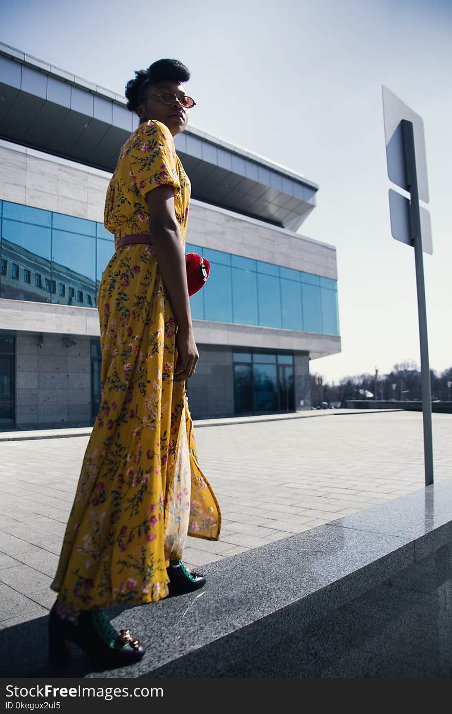 Woman in Yellow and Pink Floral Dress Standing