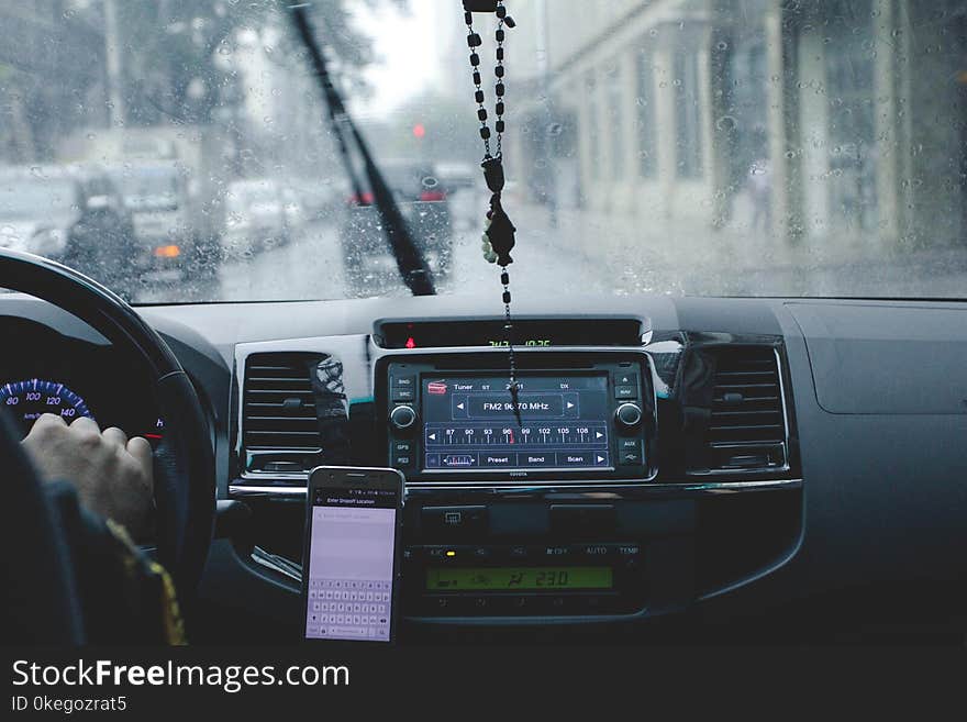 Photo of Person Driving Car While Raining