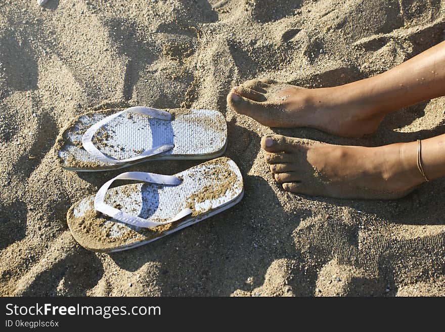 Photography of a Girl&#x27;s Feet Near Flip-flops