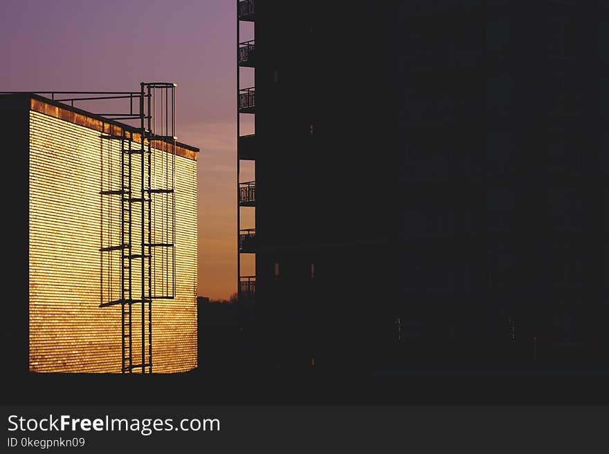 Silhouette of Building during Golden House Photo