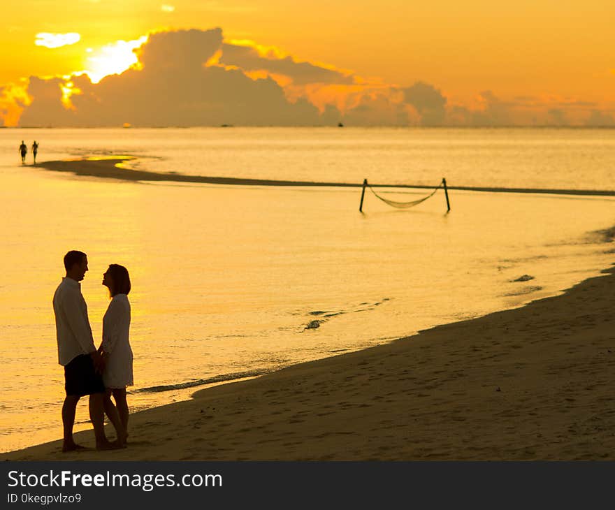 Man and Woman Facing Each Other in Front of Golden Hour