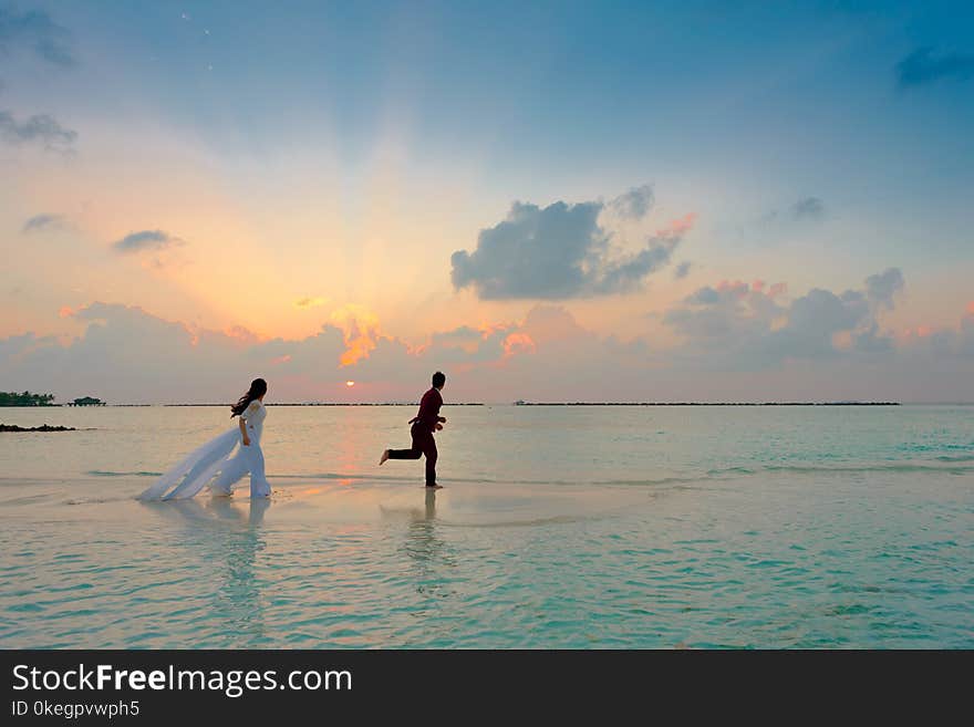 Man and Woman Standing at Seashore