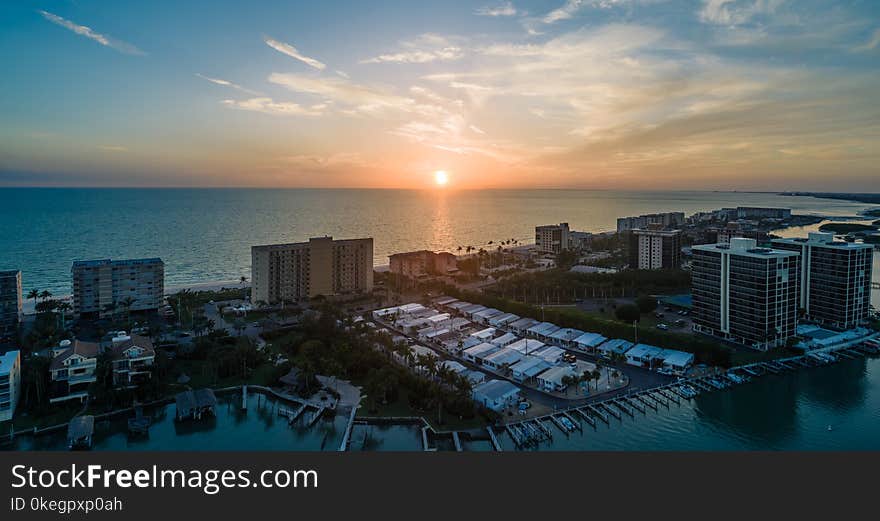 Skycraper Near Ocean Under Sunset