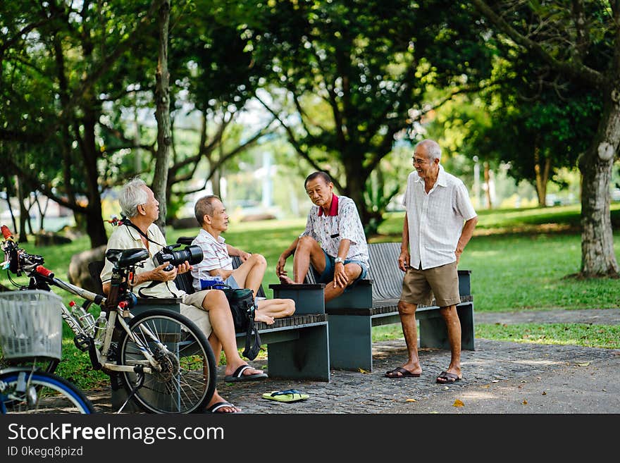 Photo of Group of Men in Sitting On Bench