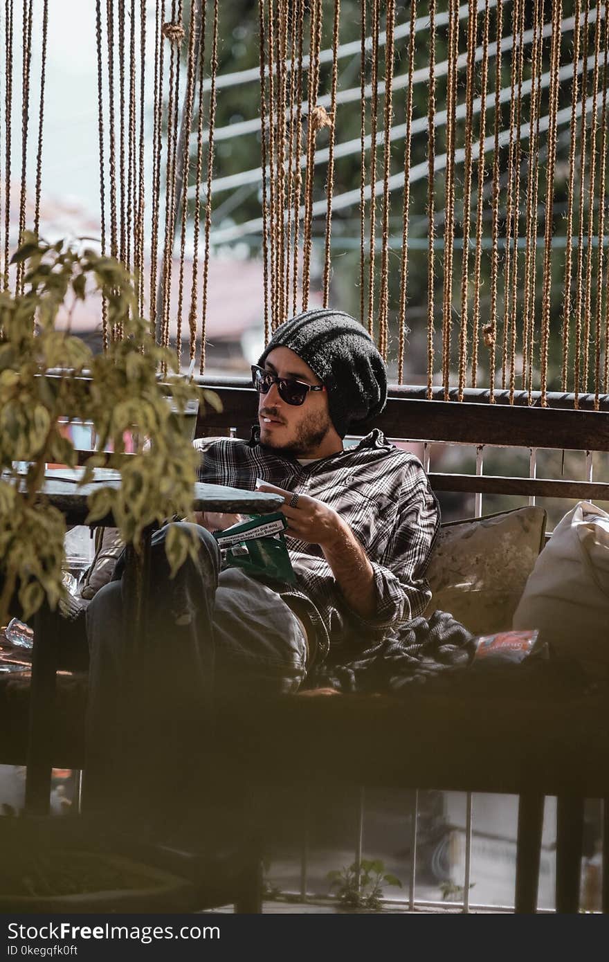 Man Wearing Button-up Shirt and Black Knit Cap at Sofa