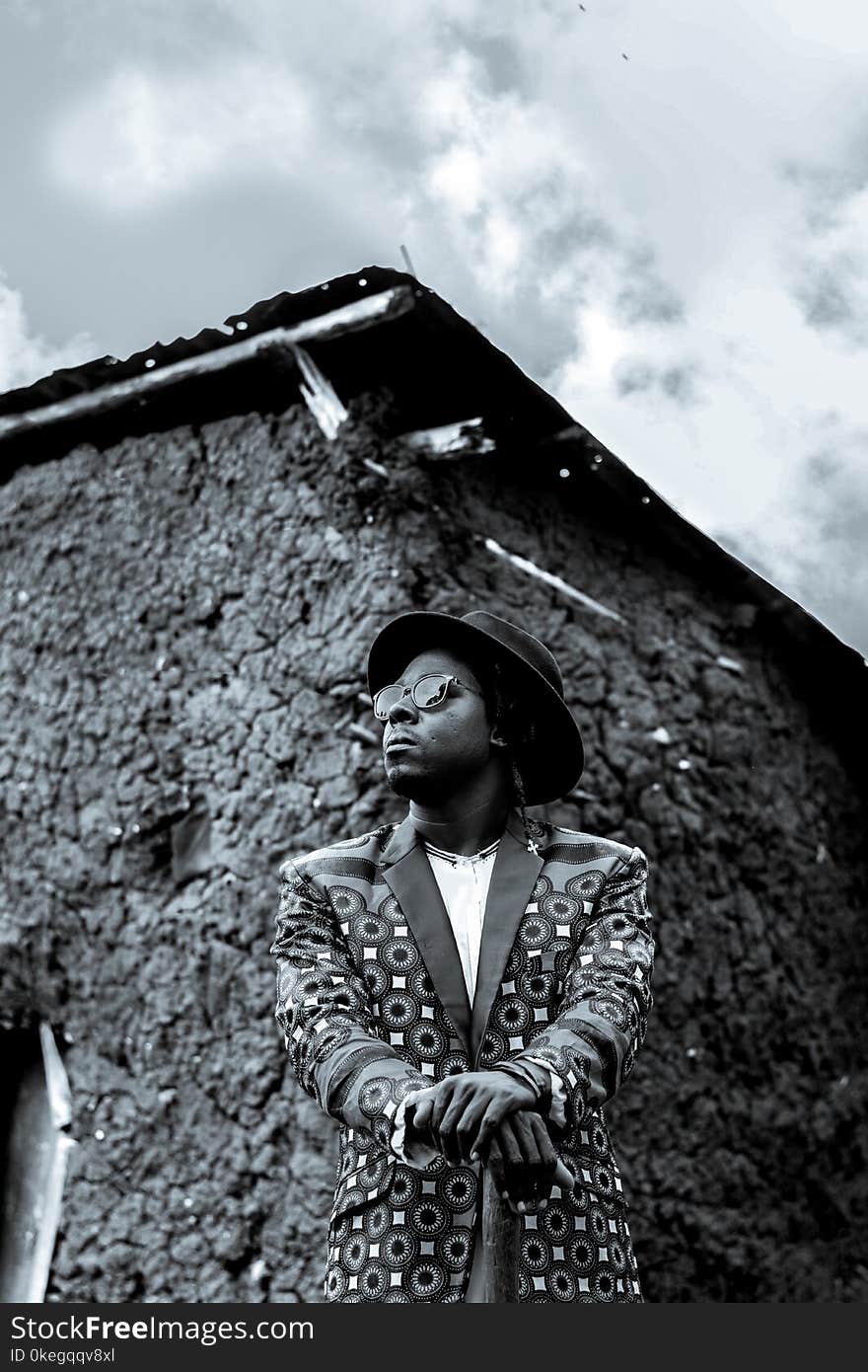 Man Wearing Hat and Suit Jacket in Grayscale Photography