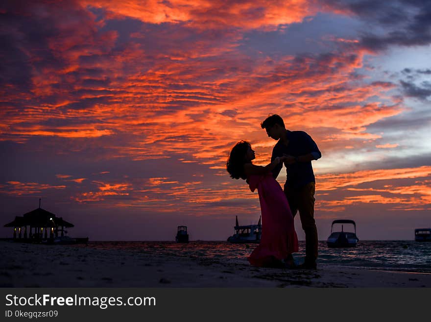 Man and Woman on Beach during Sunset