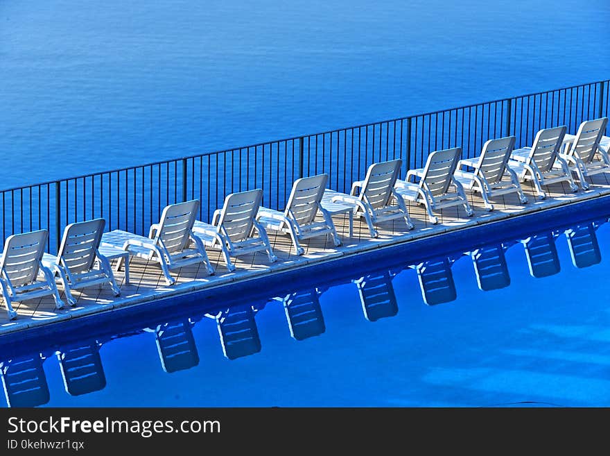 Row of free sunbeds at the swimming pool in a touristic resort