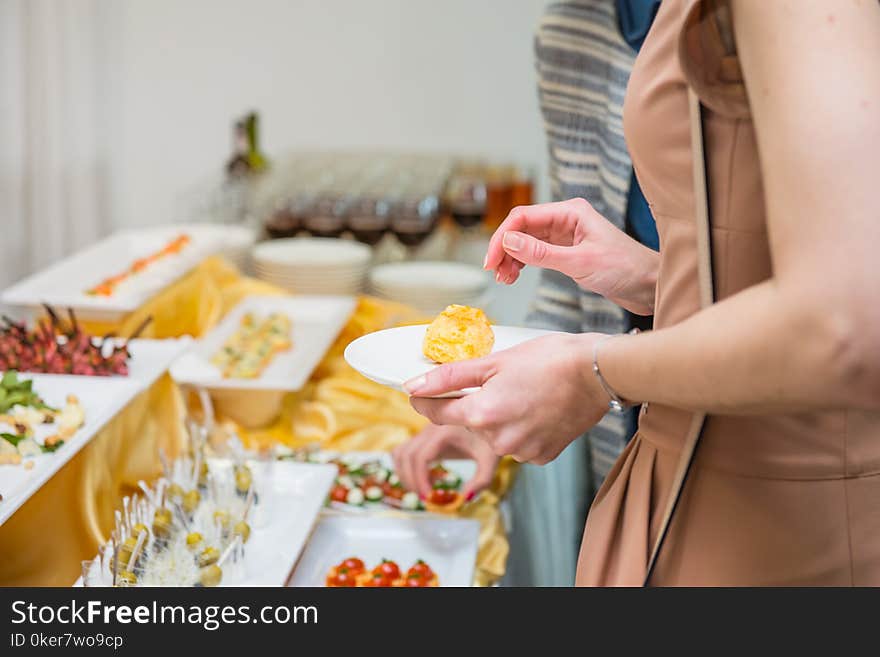 Catering buffet table with food and snacks for guests of the event. Group of people in all you can eat. Dining Food Celebration Party Concept. Service at business meeting, weddings. Selective focus