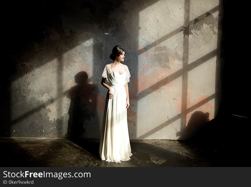 Portrait of beauty bride in white dress. bride`s fees.