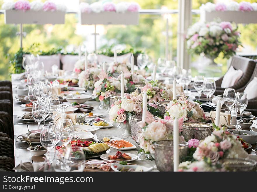 Garland of flowers and greenery for table decoration. Luxury wedding reception in restaurant. Stylish decor and adorning