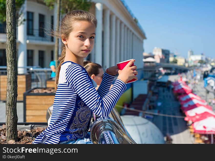 Portrait of a cool girl 10 years old, City Embankment, European city