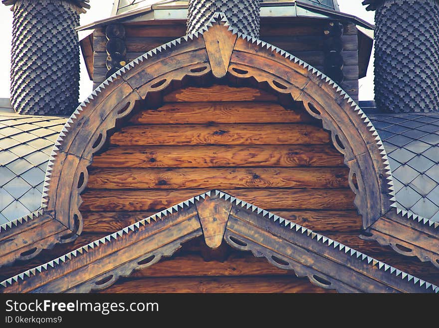 Fragment of a log house with elements of Russian architecture, wooden carvings.