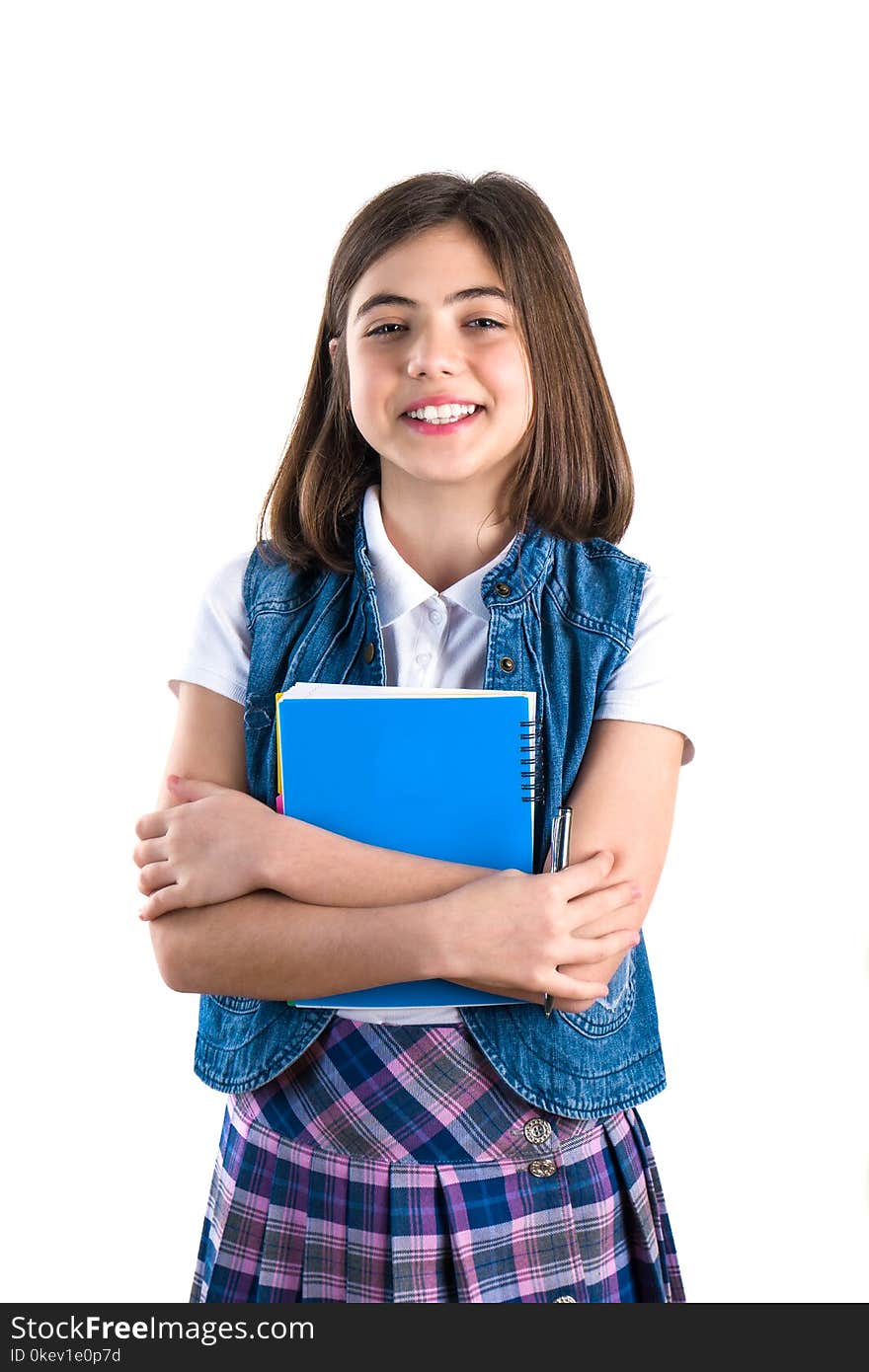 Beautiful girl in school uniform with a notebook in her hand on a white background.