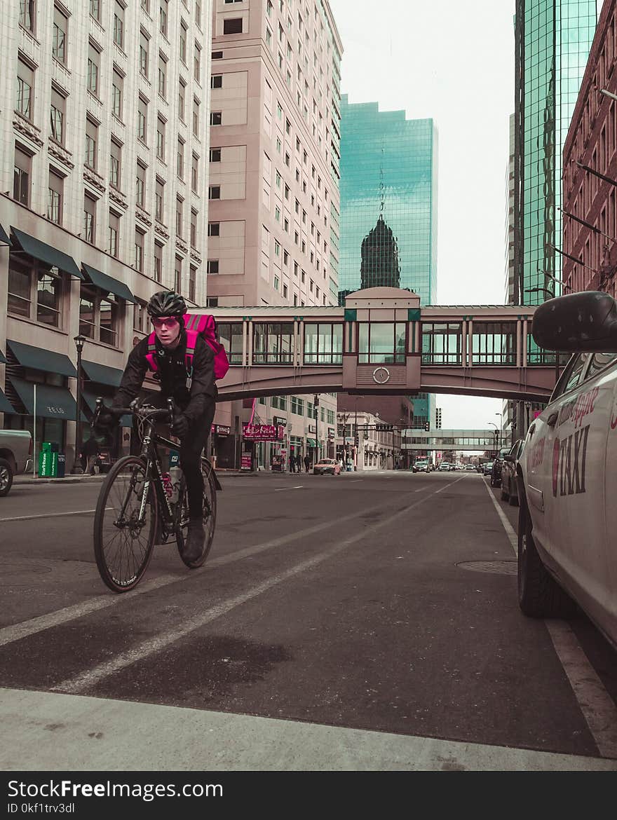 Photo of Man Riding Bicycle on the Road