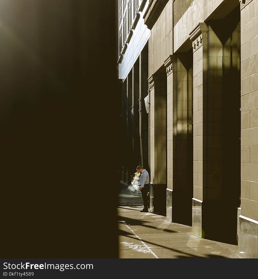 Man standing next to a building