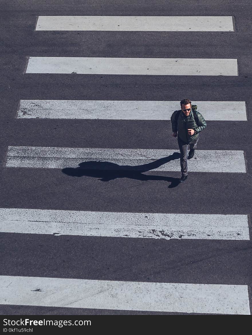 Man Crossing on Pedestrian Lane