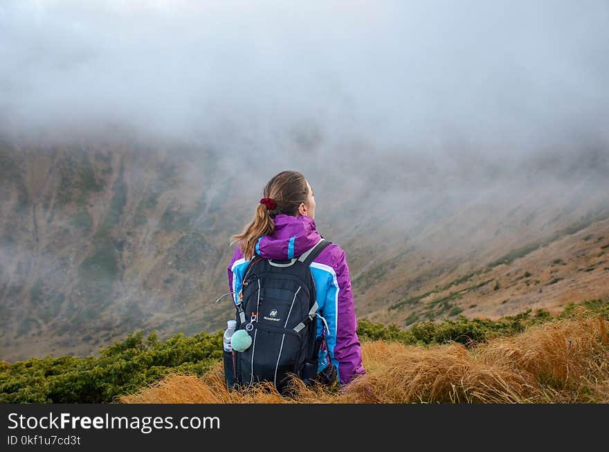 Woman Standing on Mountain Wearing Black Backpack