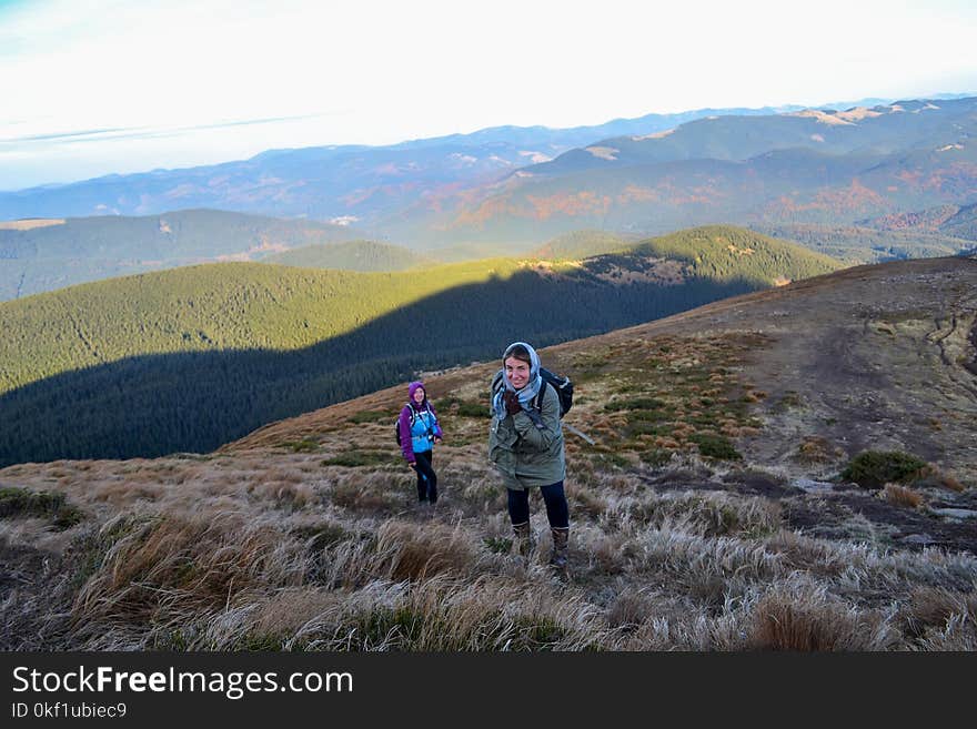 Two Women Trekking Up a Mountain