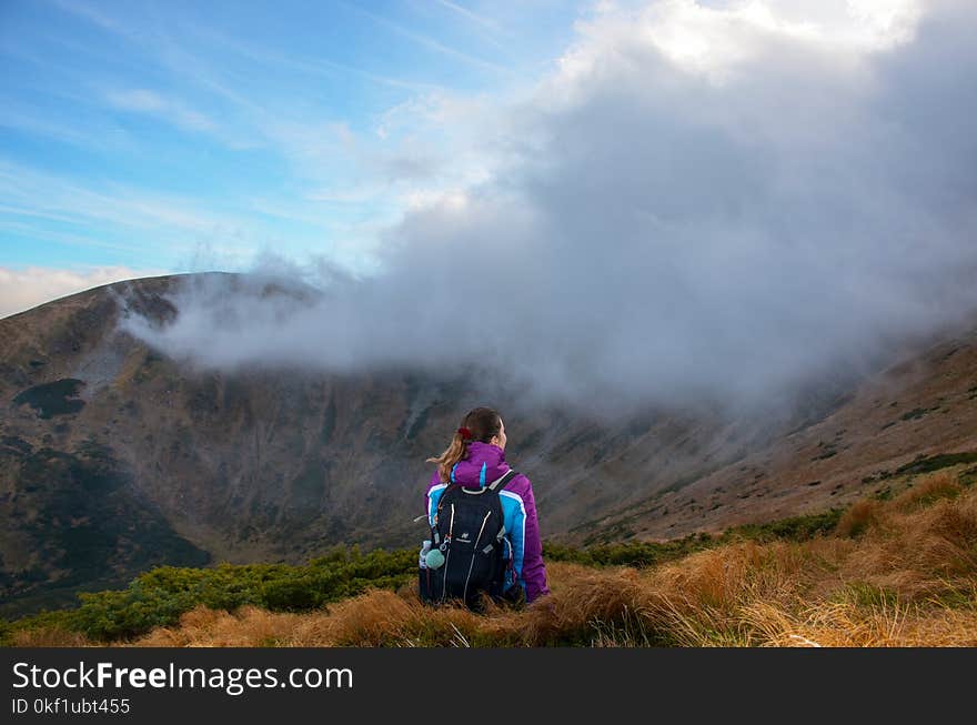 Photography of Woman Wearing Jacket on Mountain Peak