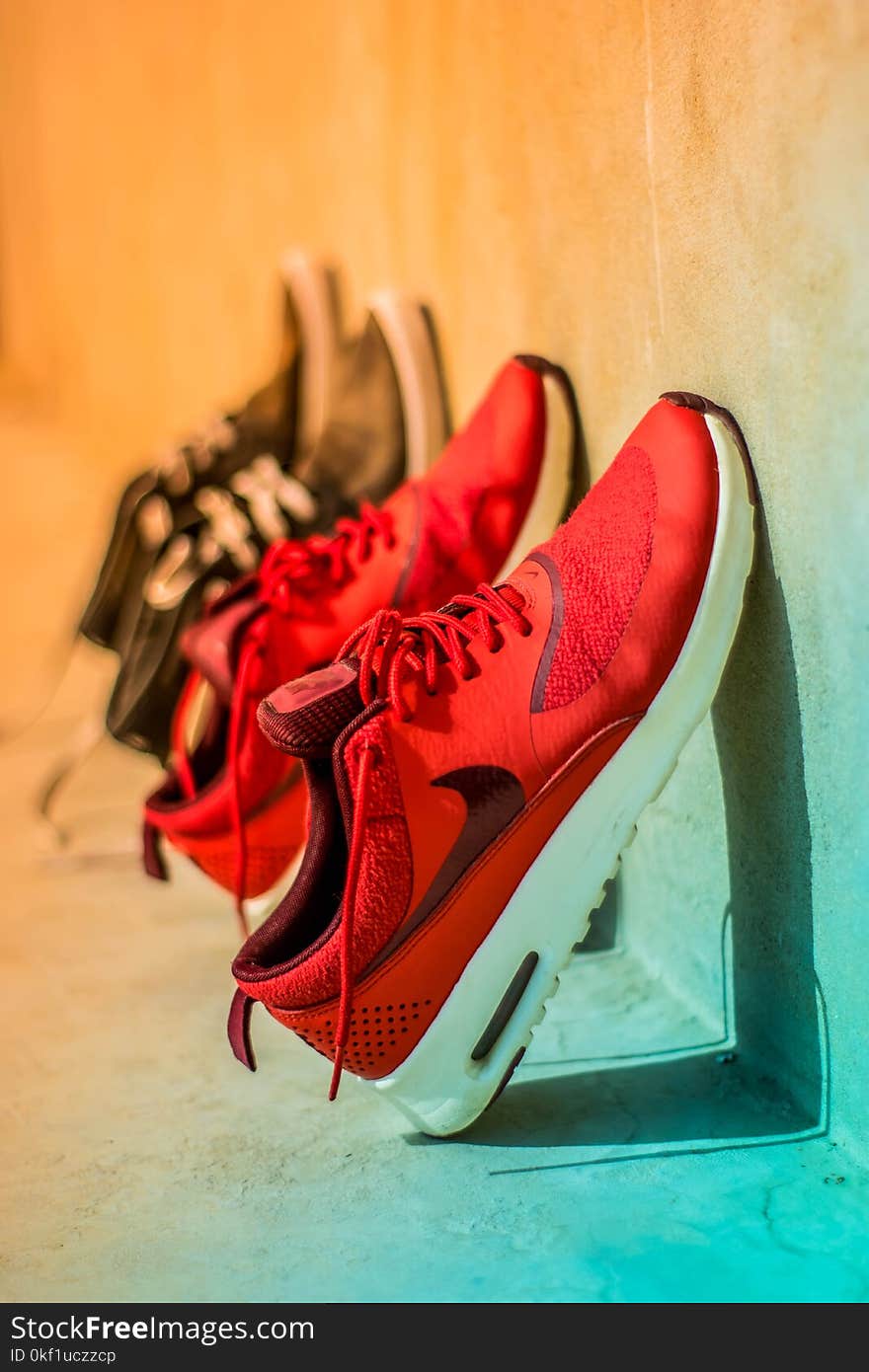 Focus Photography of Pair of Red Nike Running Shoes