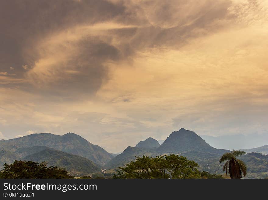 Scenic View of Mountain Under Cloudy Sky