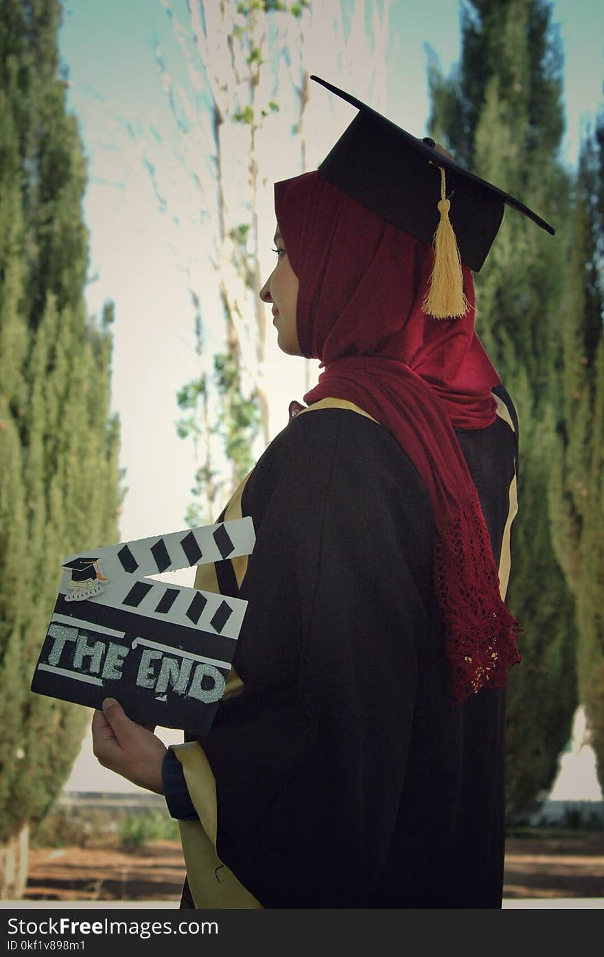 Woman Wearing Academic Dress While Holding Clipperboard