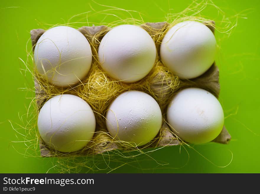 Close-up View of Raw Chicken Eggs in Egg Box