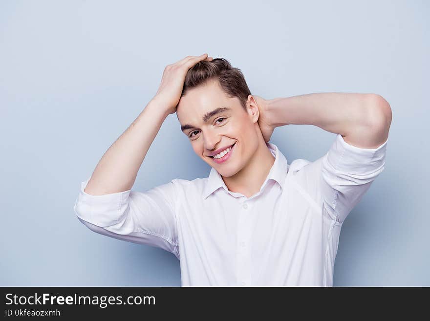 Portrait of happy with beaming smile young guy dressed in white