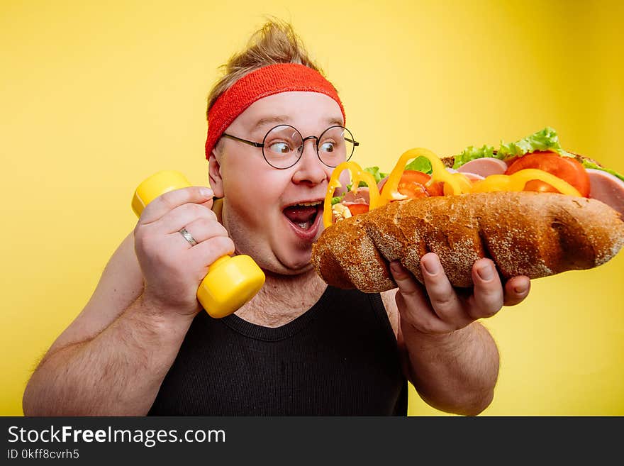 Fat funny man eating unhealthy big burger. Fat funny man eating unhealthy big burger