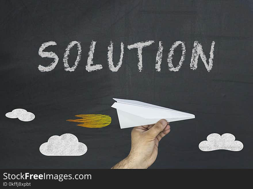 Solution word on the blackboard. Paper plane. Solution word on the blackboard. Paper plane