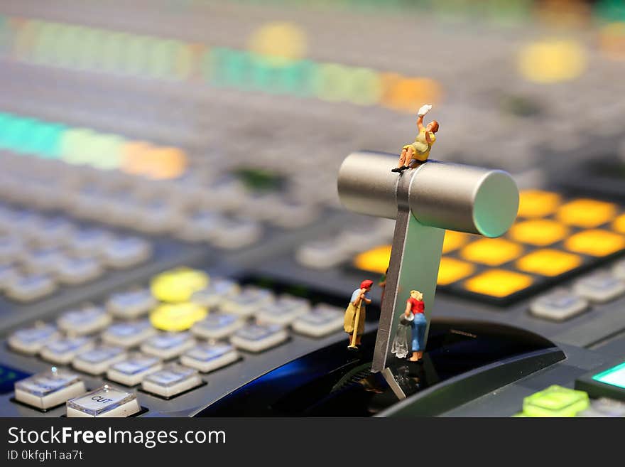 Miniature people : Maid or Housewife cleaning on Switcher buttons in studio TV station, Audio and Video Production Switcher of Television Broadcast.