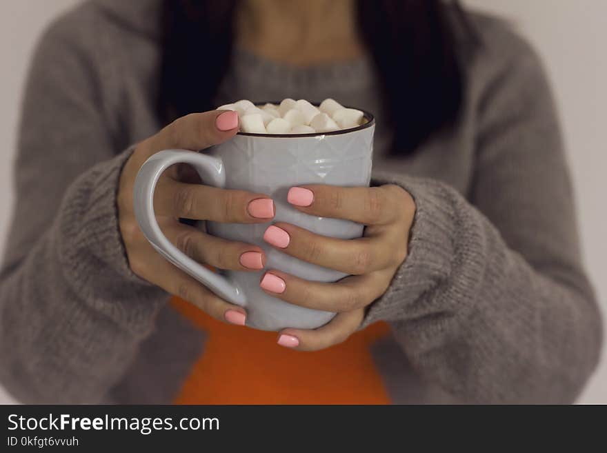 Blue Cup Of Cocoa Coffee With Marshmallow In Hands Of Girl