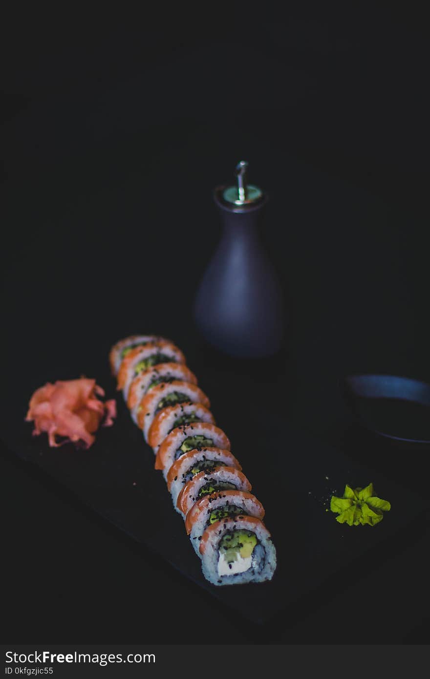 Sushi and Oil Bottle on Top of Table