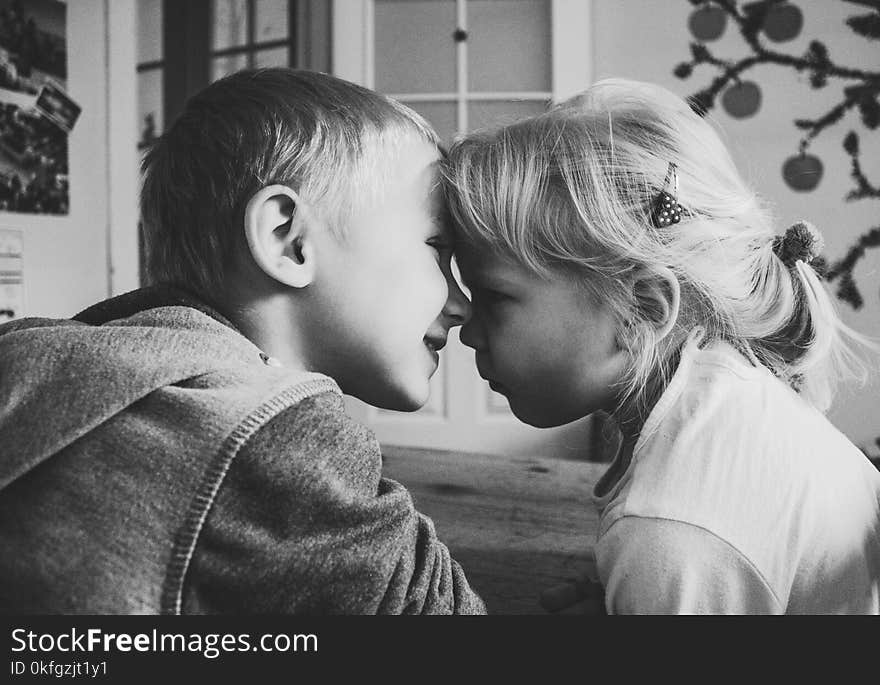 Girl Wearing White Top Beside Boy Wearing Hoodie