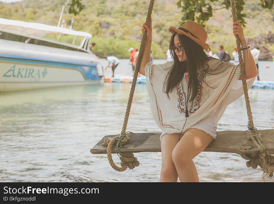 Woman on Swing Near Body of Water