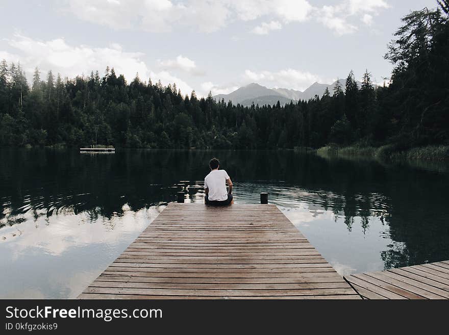 Man Sitting on Dock