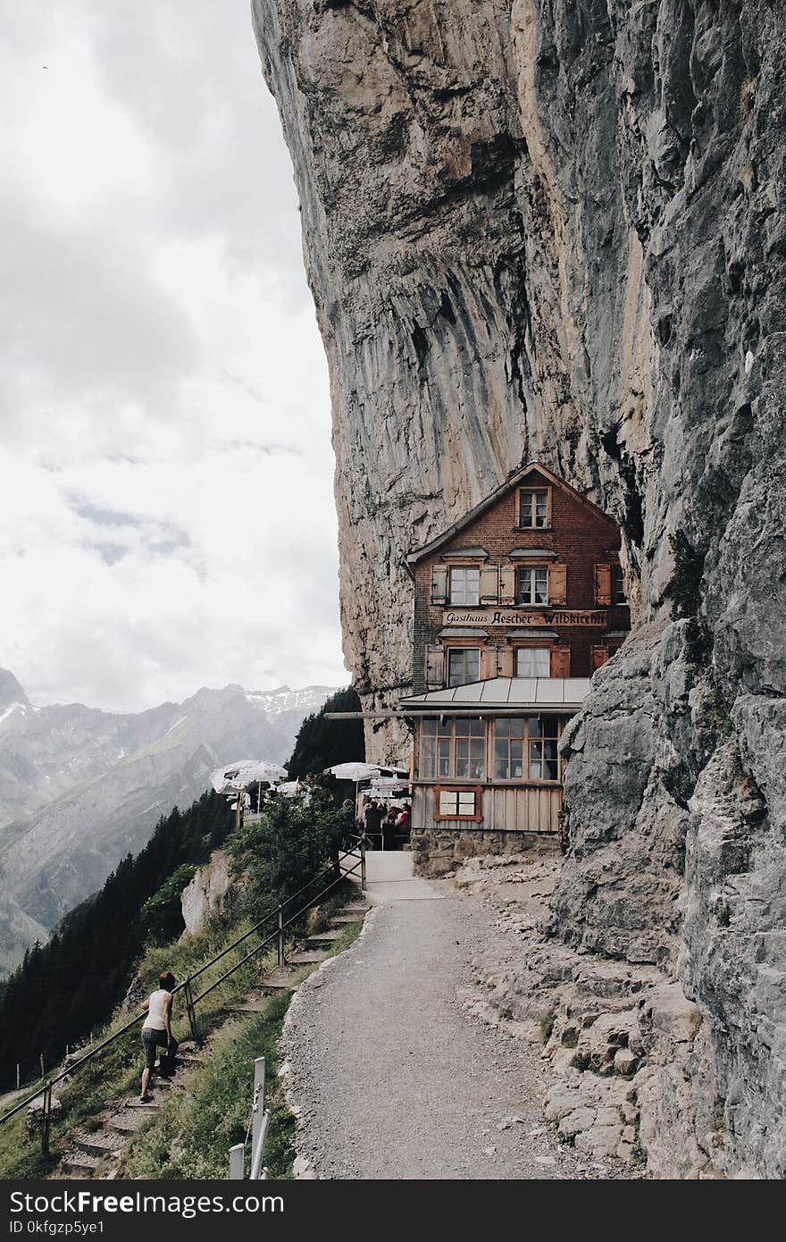 Brown Wooden House on Edge of Cliff