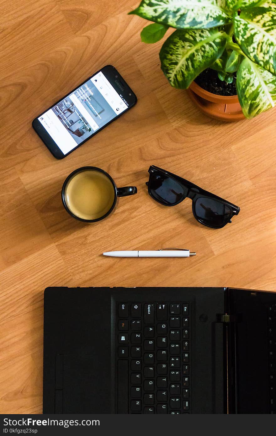 Black Sunglasses on Brown Wooden Surface