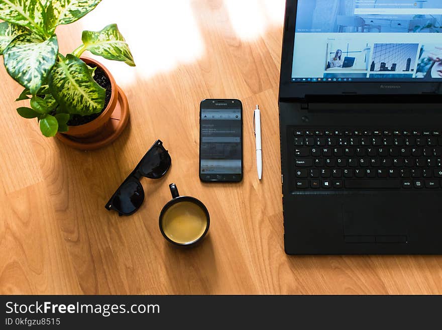 Black Sunglasses With Black Frames Beside Black Smartphone