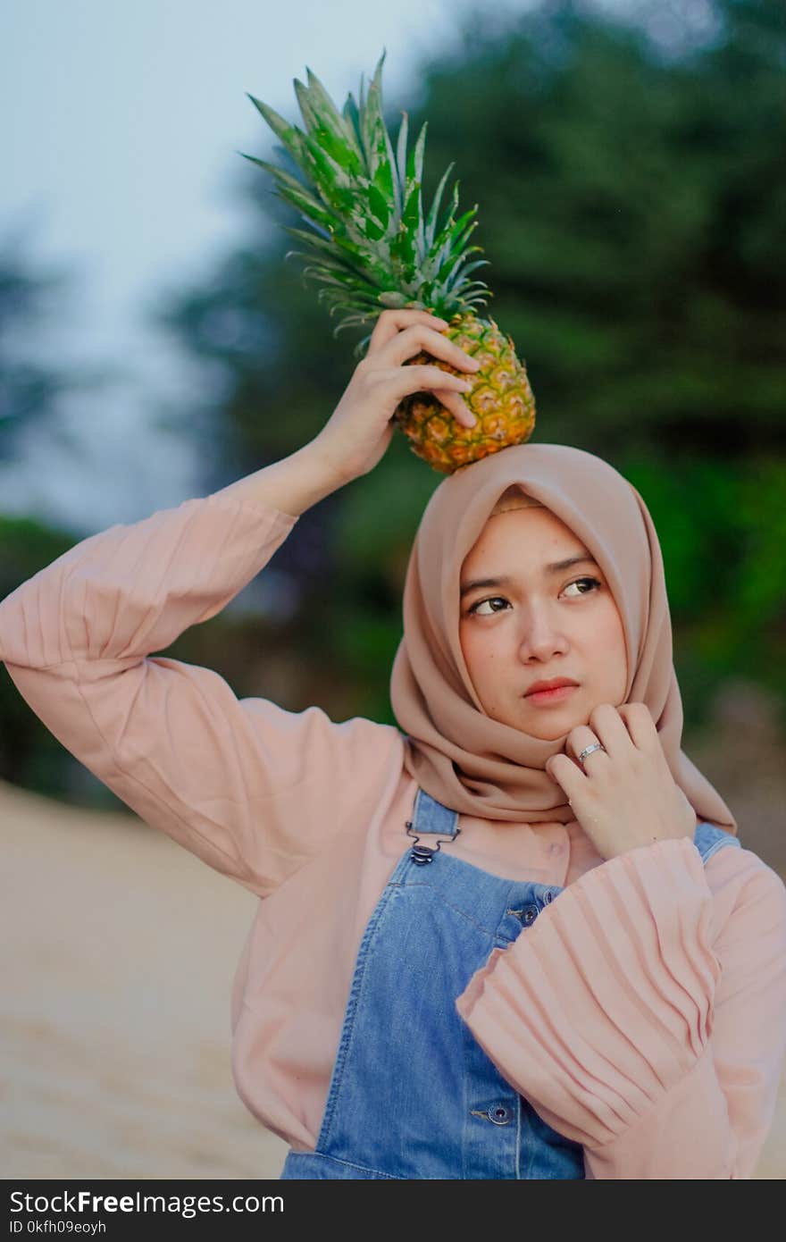 Woman Holding Pineapple on Her Head