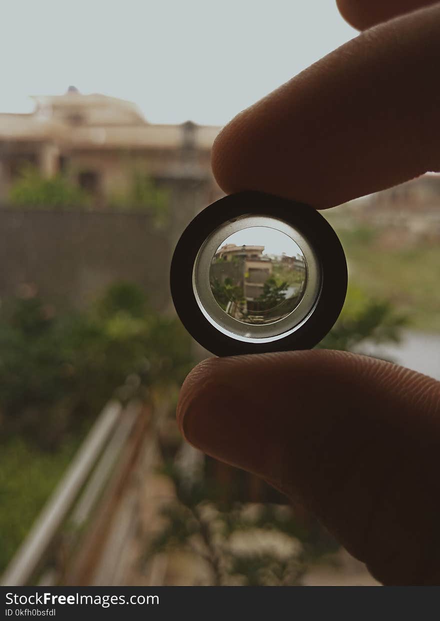 Person Holding Black Lens