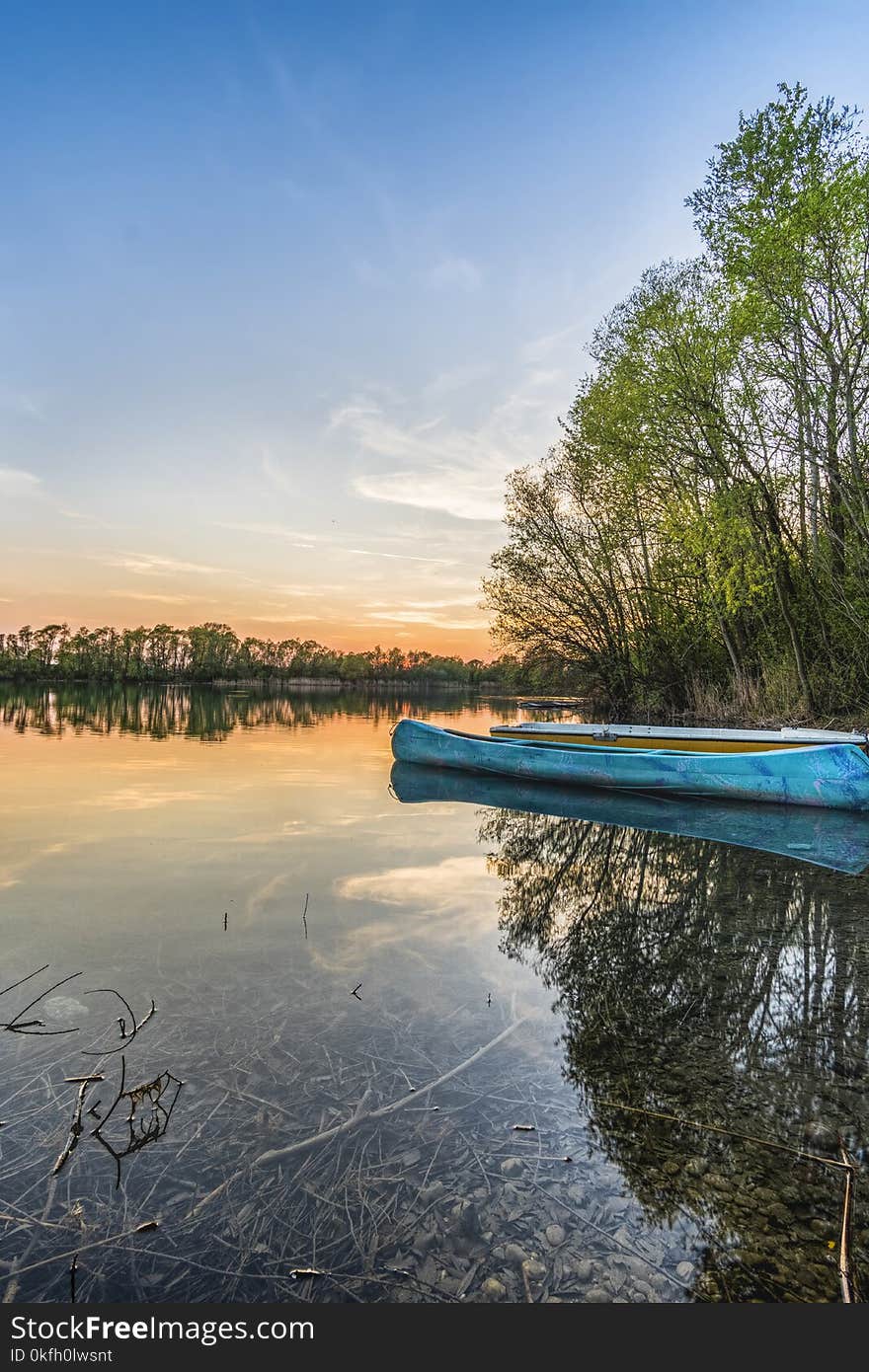 Blue Canoe on Water Beside Trees