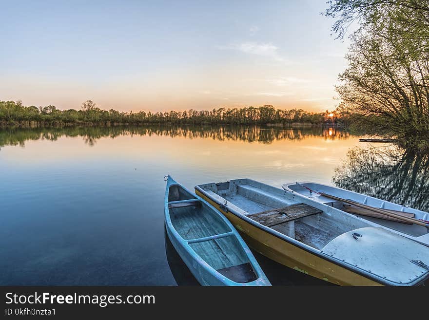 Three Boats on Calm Body of Water